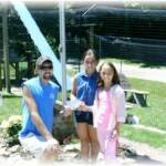 Bella (in blue) and Adriana (in pink) are presenting a check for $52 to Terry Craft from money they earned selling donut holes at the Farmer’s Market while visiting with their grandmother for the summer!  Thanks so very much!
